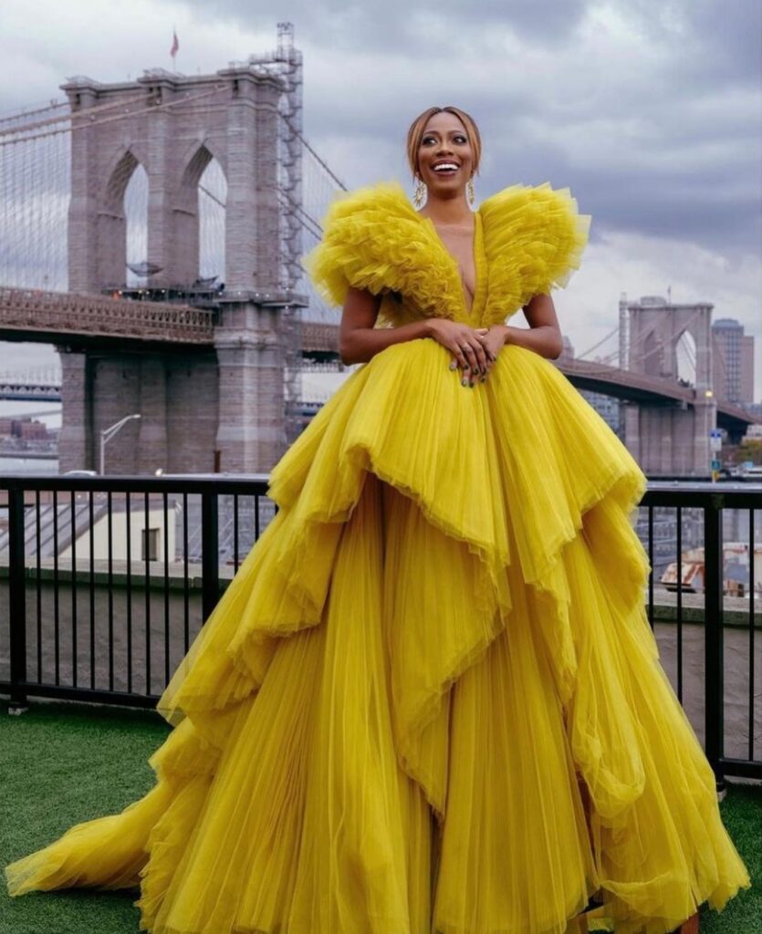 Yvonne Orji wearing a merigold tulle gown